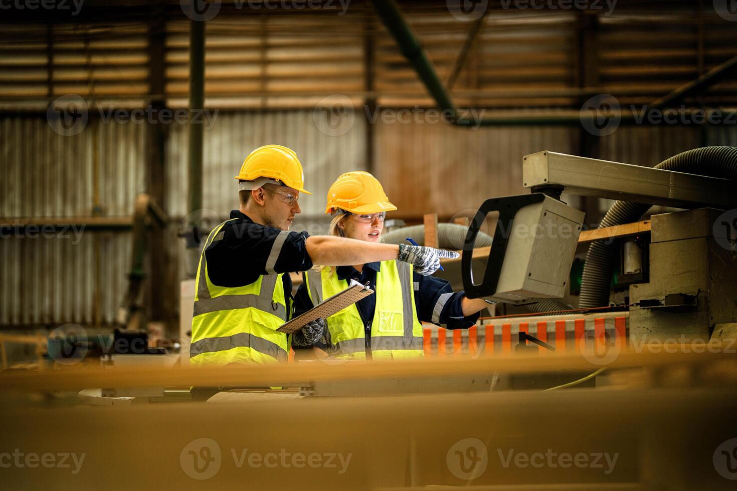 actory engineer workers standing to control panel switch. people works at heavy machine at industry factory. with machinery equipment plant technology. smart industry worker operating. photo