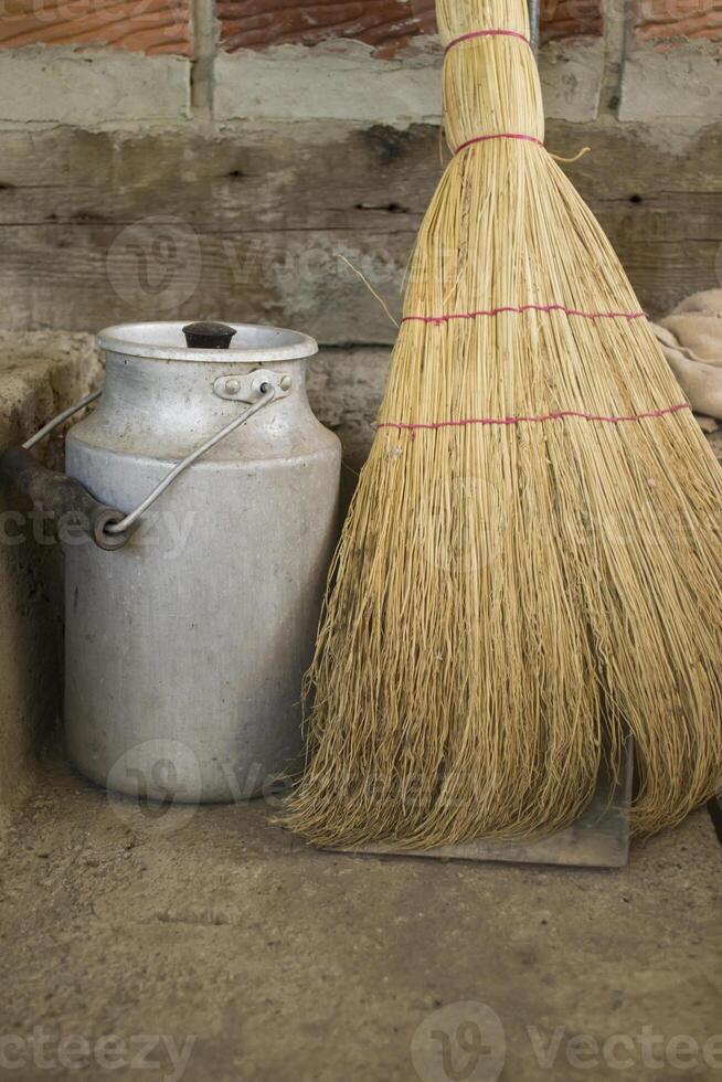 The milk jar and broom. Retro style. photo