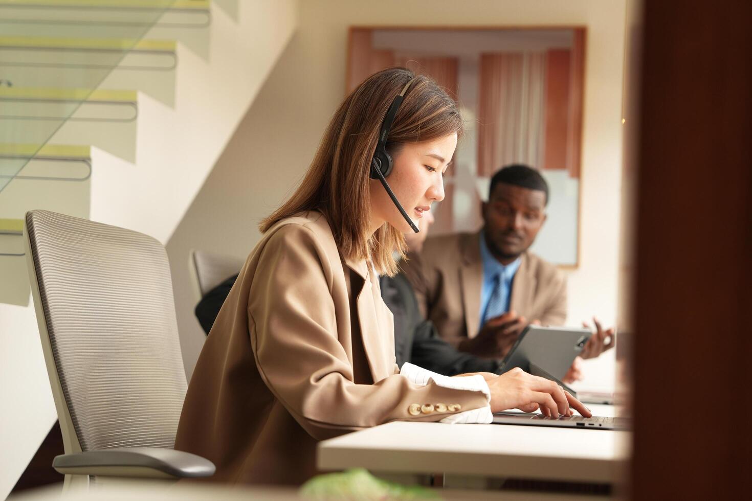 Asian operator working in office. Young friendly operator woman agent with headsets working in a call centre. photo