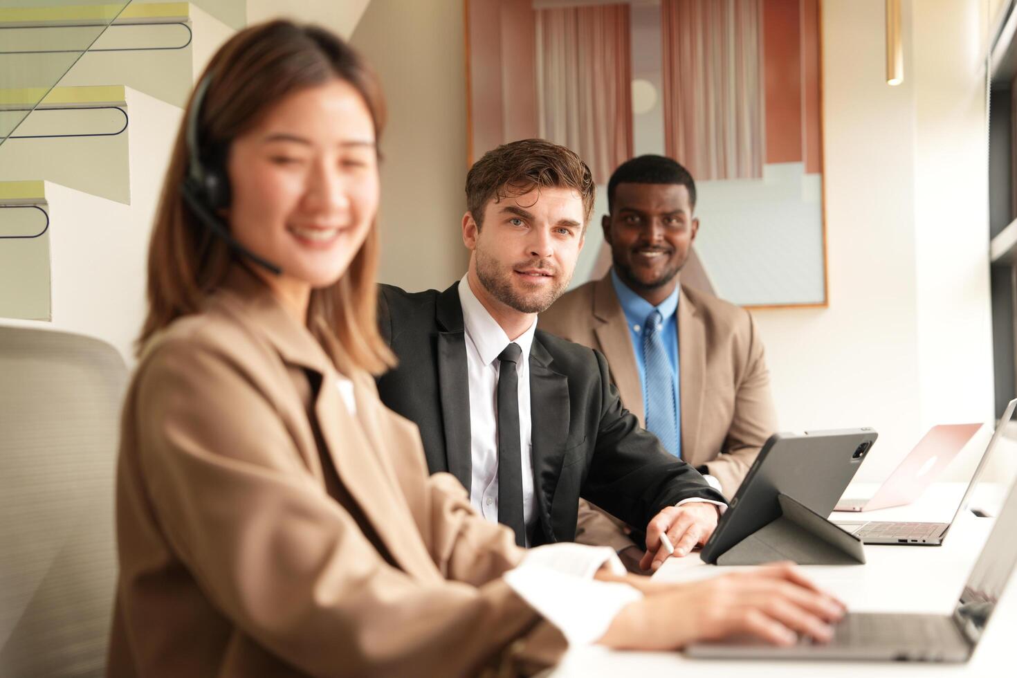 Asian operator working in office. Young friendly operator woman agent with headsets working in a call centre. photo
