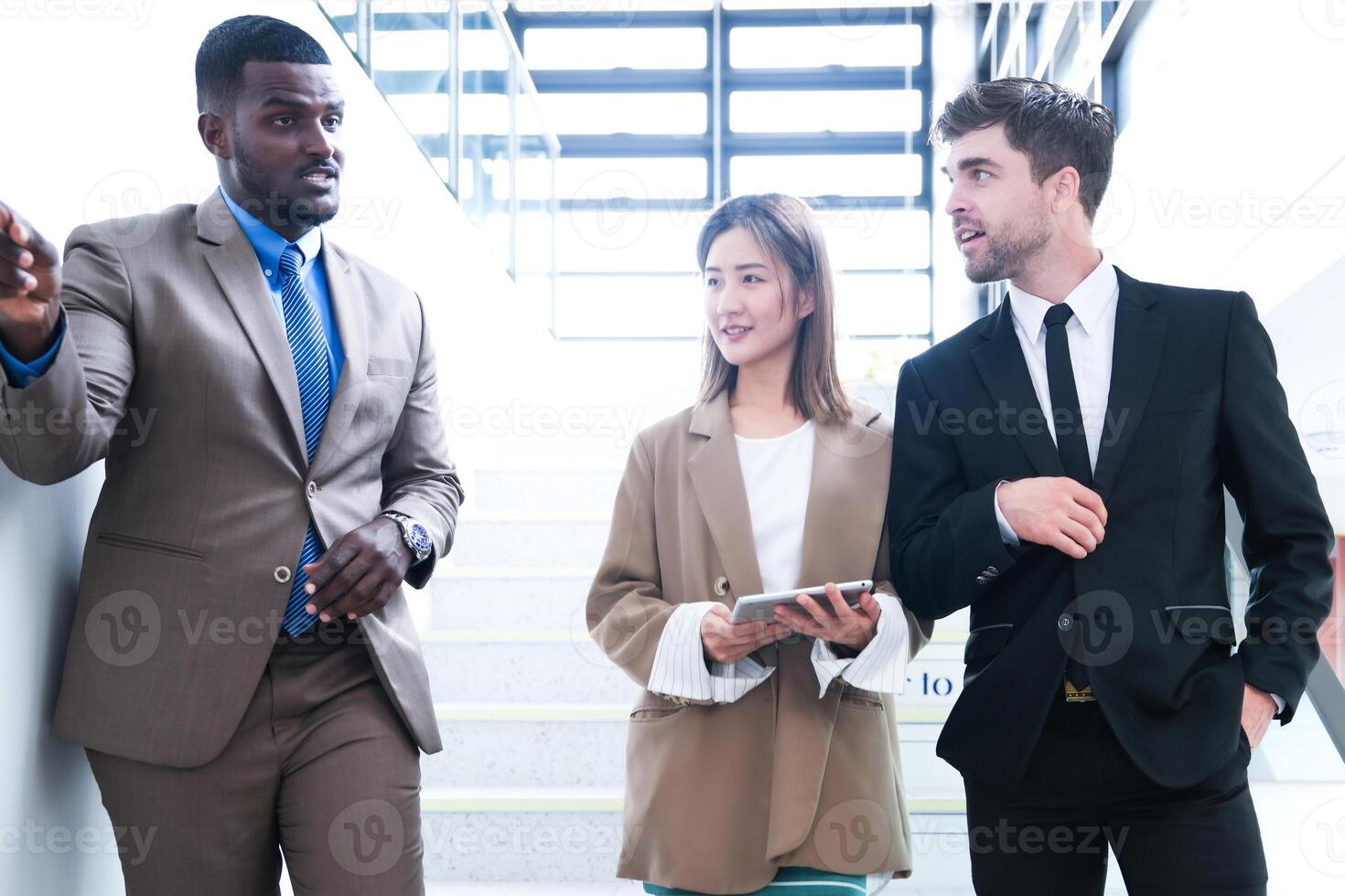 Business people shaking hands. finishing up a meeting. team of business people walk in rush hour at indoor pedestrian stairs and talk together. concept negotiations in feeling successful and happy. photo