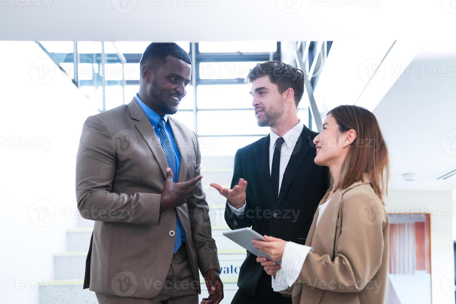 Business people shaking hands. finishing up a meeting. team of business people walk in rush hour at indoor pedestrian stairs and talk together. concept negotiations in feeling successful and happy. photo