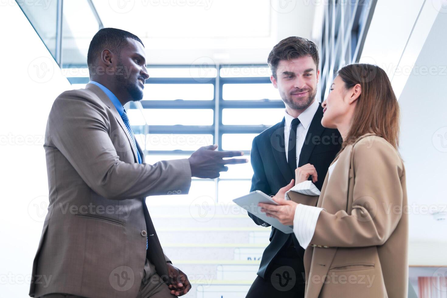 Business people shaking hands. finishing up a meeting. team of business people walk in rush hour at indoor pedestrian stairs and talk together. concept negotiations in feeling successful and happy. photo