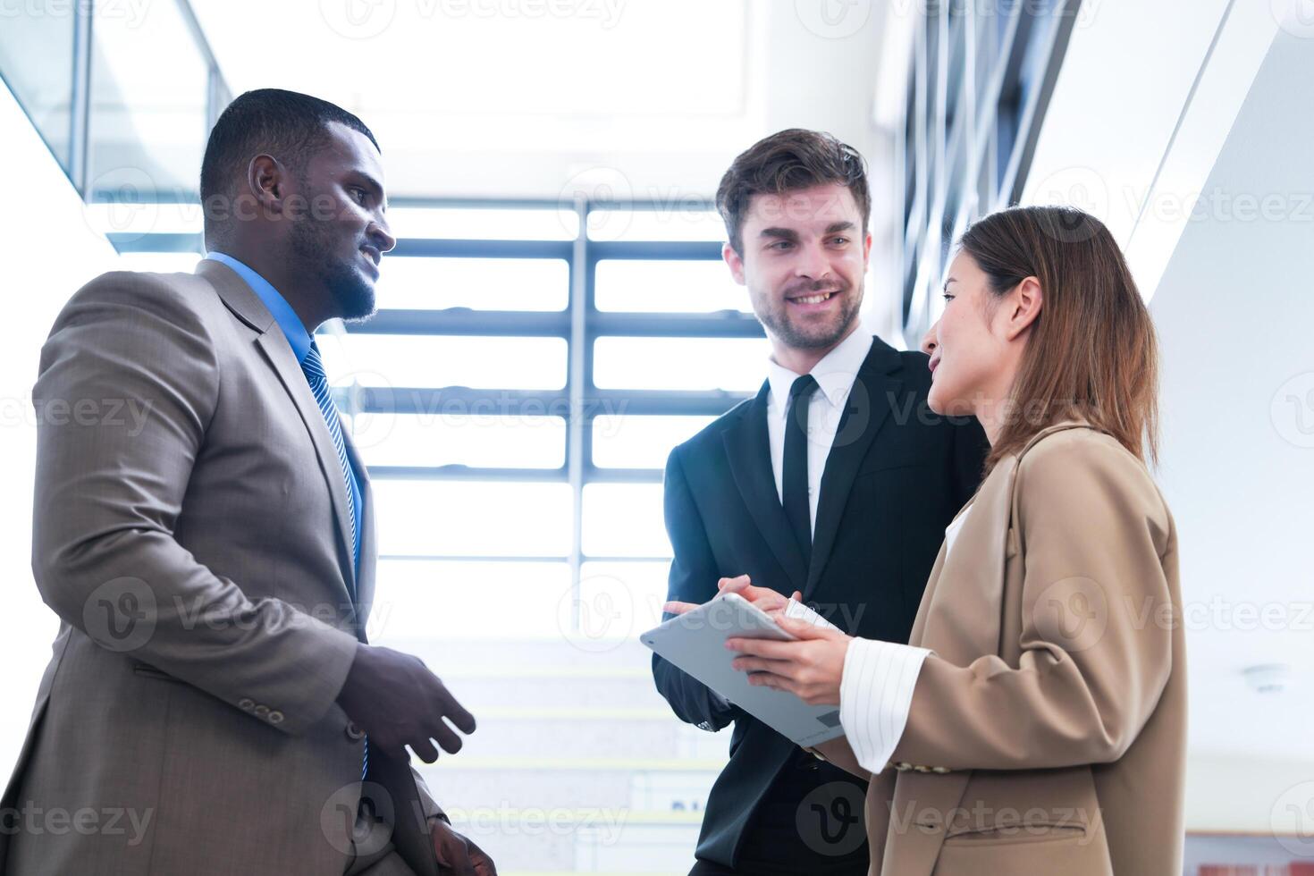 Business people shaking hands. finishing up a meeting. team of business people walk in rush hour at indoor pedestrian stairs and talk together. concept negotiations in feeling successful and happy. photo