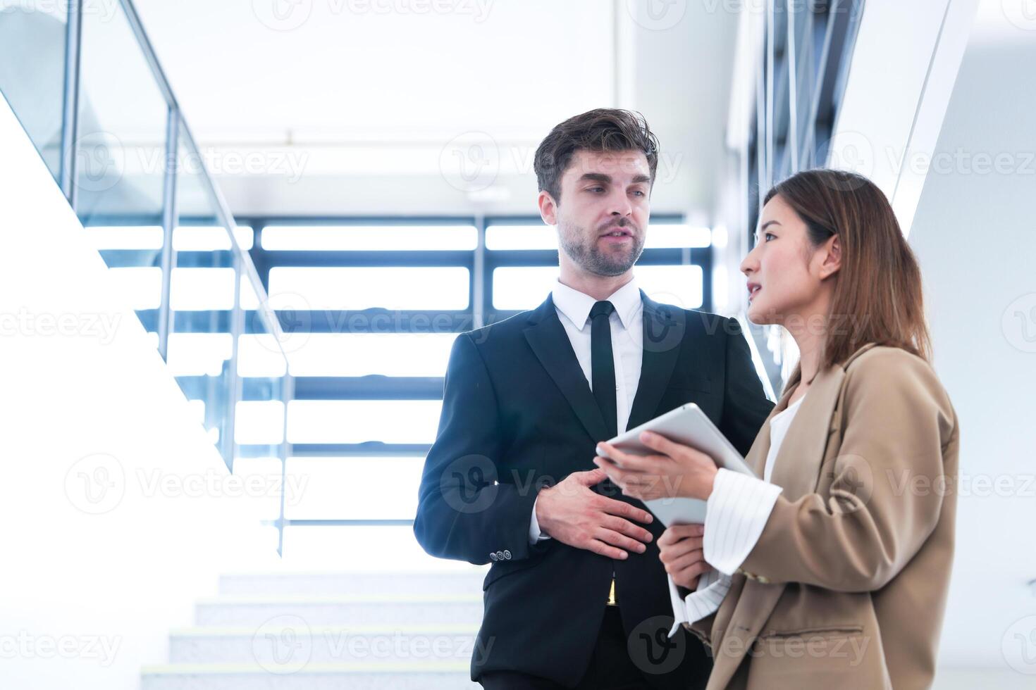 Business people shaking hands. finishing up a meeting. team of business people walk in rush hour at indoor pedestrian stairs and talk together. concept negotiations in feeling successful and happy. photo