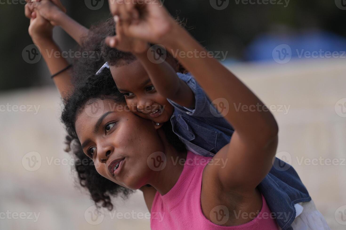 Mixed race African and Asian mother and boy is playing at the outdoor area. smiling happy family have fun running on the beach. portrait of mom and kid lifestyle with a unique hairstyle. photo