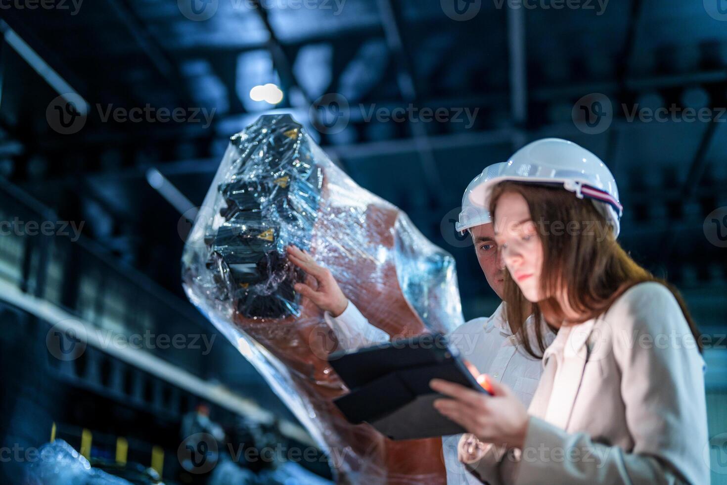 Sales manager and factory owner in suits negotiating selling robots used in the factory. Business engineers meeting and checking new machine robot. Workers walking at warehouse welding machine. photo