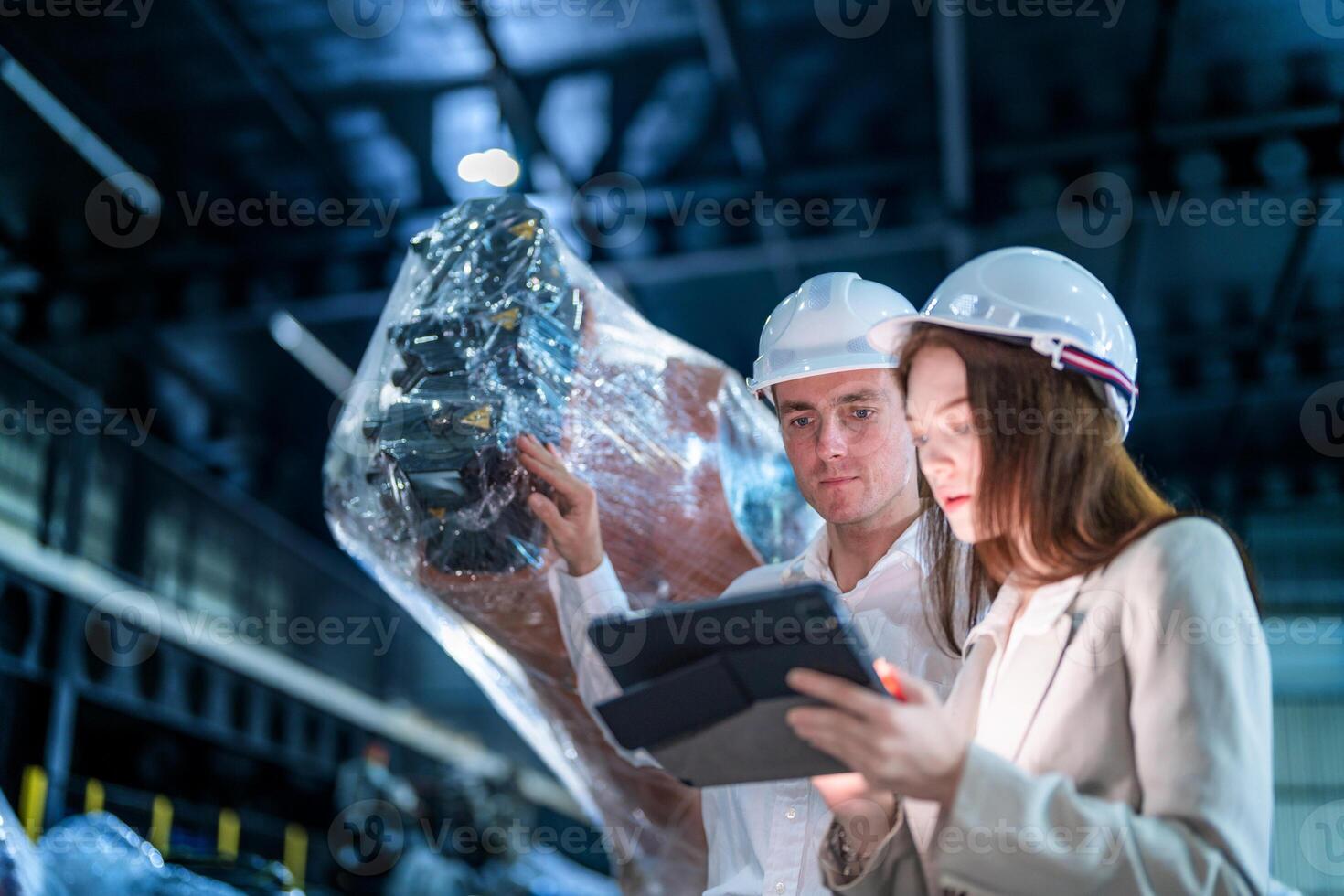 Sales manager and factory owner in suits negotiating selling robots used in the factory. Business engineers meeting and checking new machine robot. Workers walking at warehouse welding machine. photo