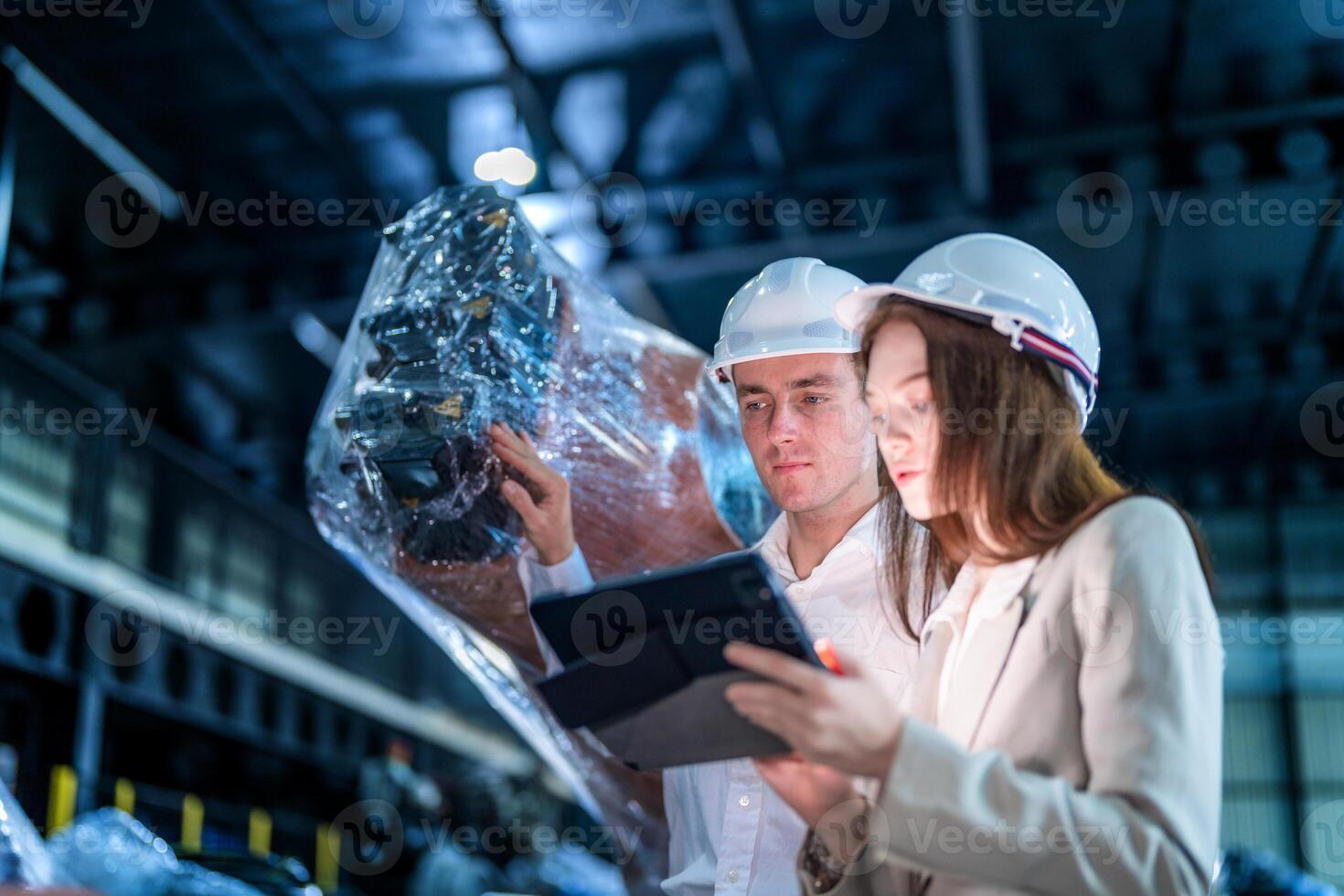 Sales manager and factory owner in suits negotiating selling robots used in the factory. Business engineers meeting and checking new machine robot. Workers walking at warehouse welding machine. photo