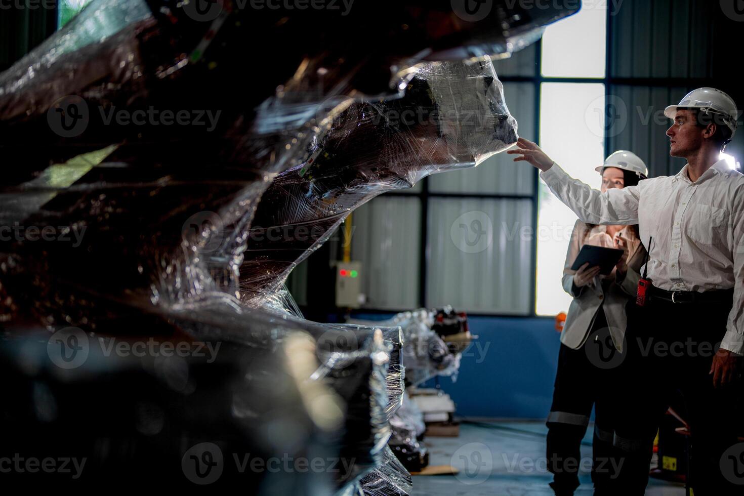 Sales manager and factory owner in suits negotiating selling robots used in the factory. Business engineers meeting and checking new machine robot. Workers walking at warehouse welding machine. photo
