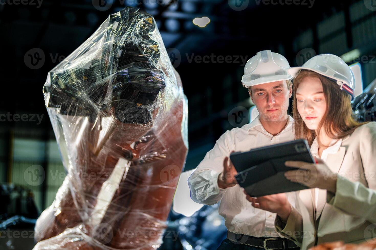 Sales manager and factory owner in suits negotiating selling robots used in the factory. Business engineers meeting and checking new machine robot. Workers walking at warehouse welding machine. photo