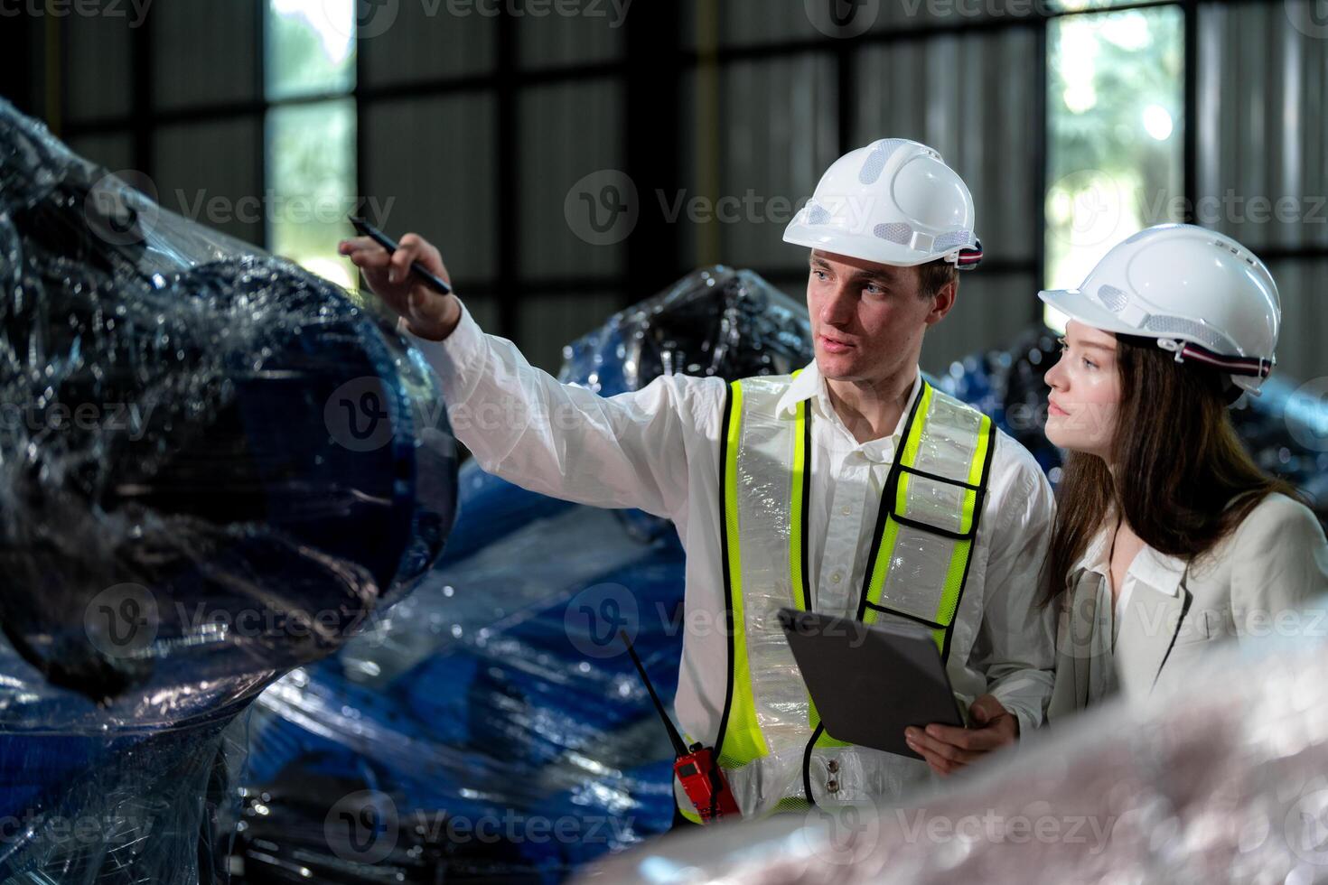 Business engineers meet and check control heavy machine robot arm. Diverse Team of Industrial Robotics Engineers Gathered Around machine. Professional Machinery Operator Use Industrial Digital Tablet. photo