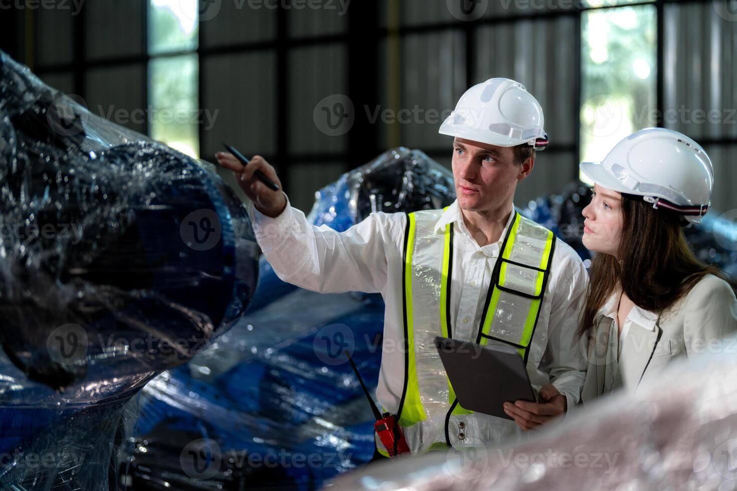 Business engineers meet and check control heavy machine robot arm. Diverse Team of Industrial Robotics Engineers Gathered Around machine. Professional Machinery Operator Use Industrial Digital Tablet. photo