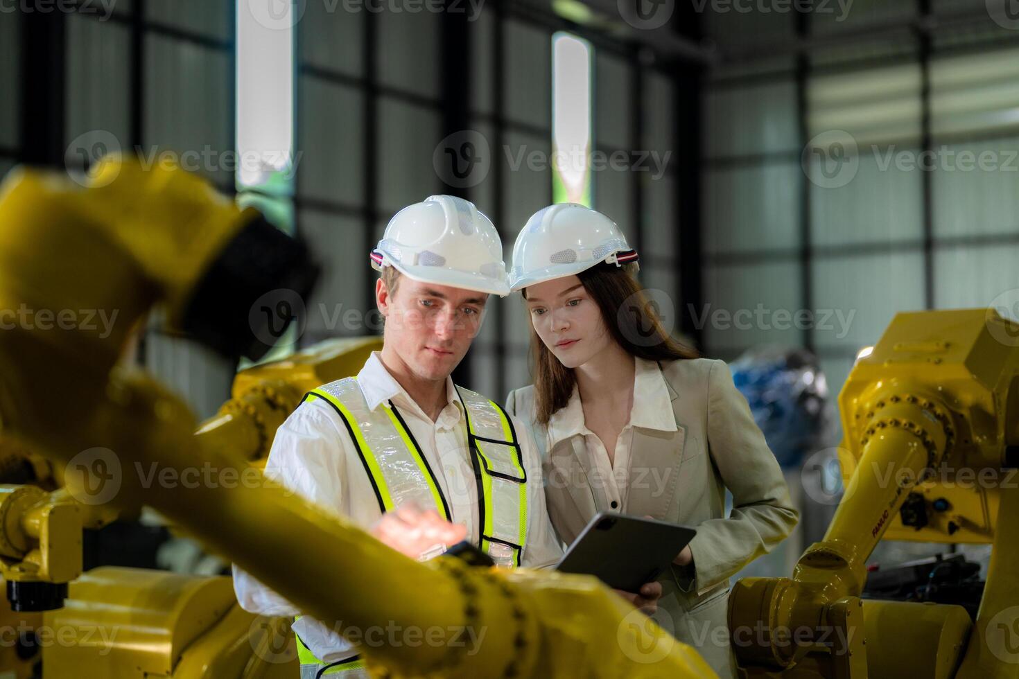 Sales manager and factory owner in suits negotiating selling robots used in the factory. Business engineers meeting and checking new machine robot. Workers walking at warehouse welding machine. photo