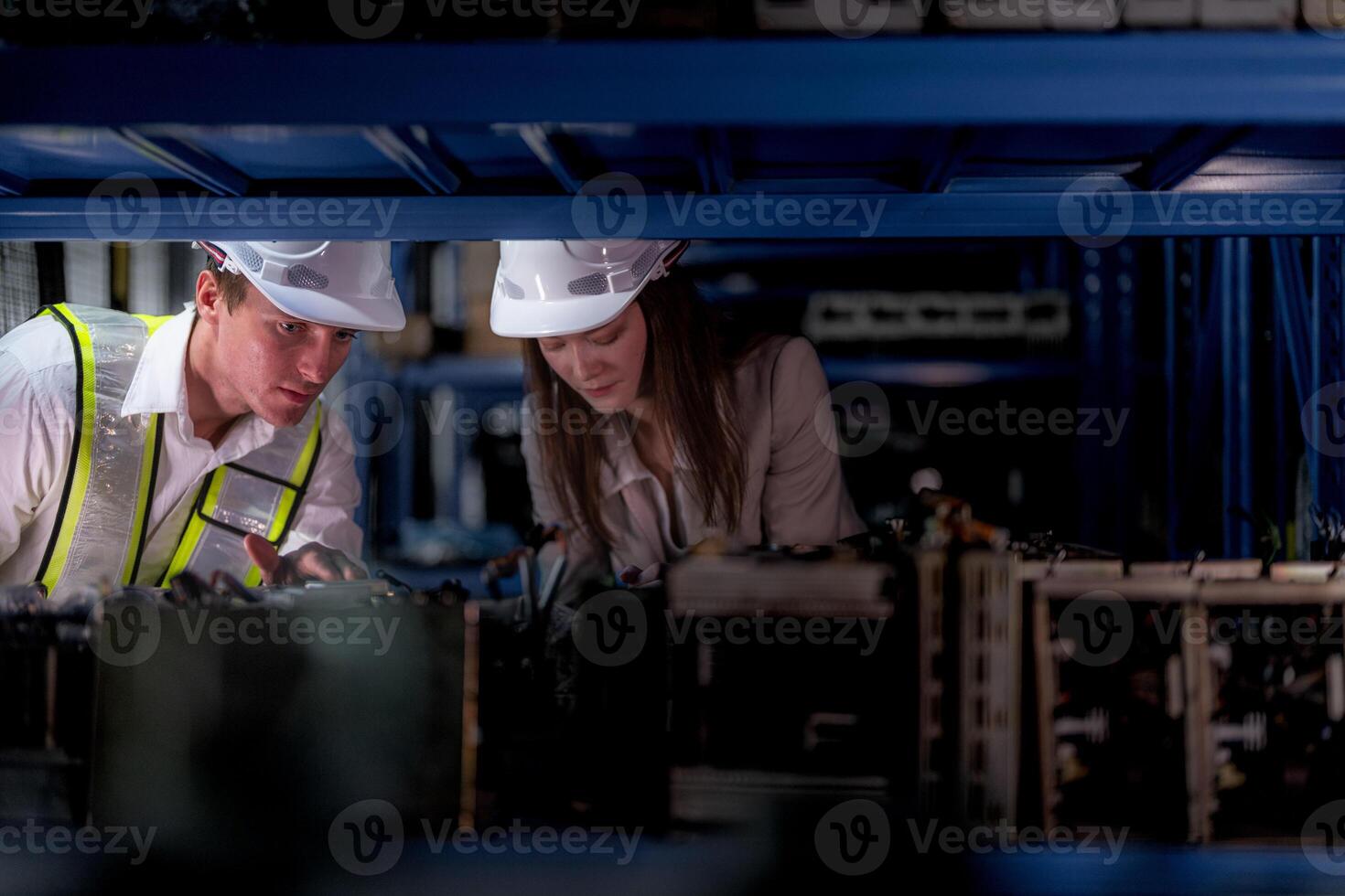 technician engineers team checking the machine and maintenance service. workers looking at spare parts in stock at warehouse factory. laborer with a checklist looking on part of machine parts. photo