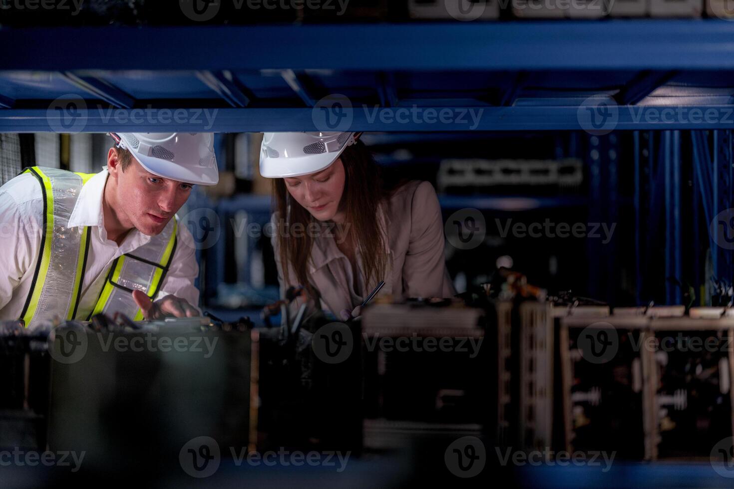 technician engineers team checking the machine and maintenance service. workers looking at spare parts in stock at warehouse factory. laborer with a checklist looking on part of machine parts. photo