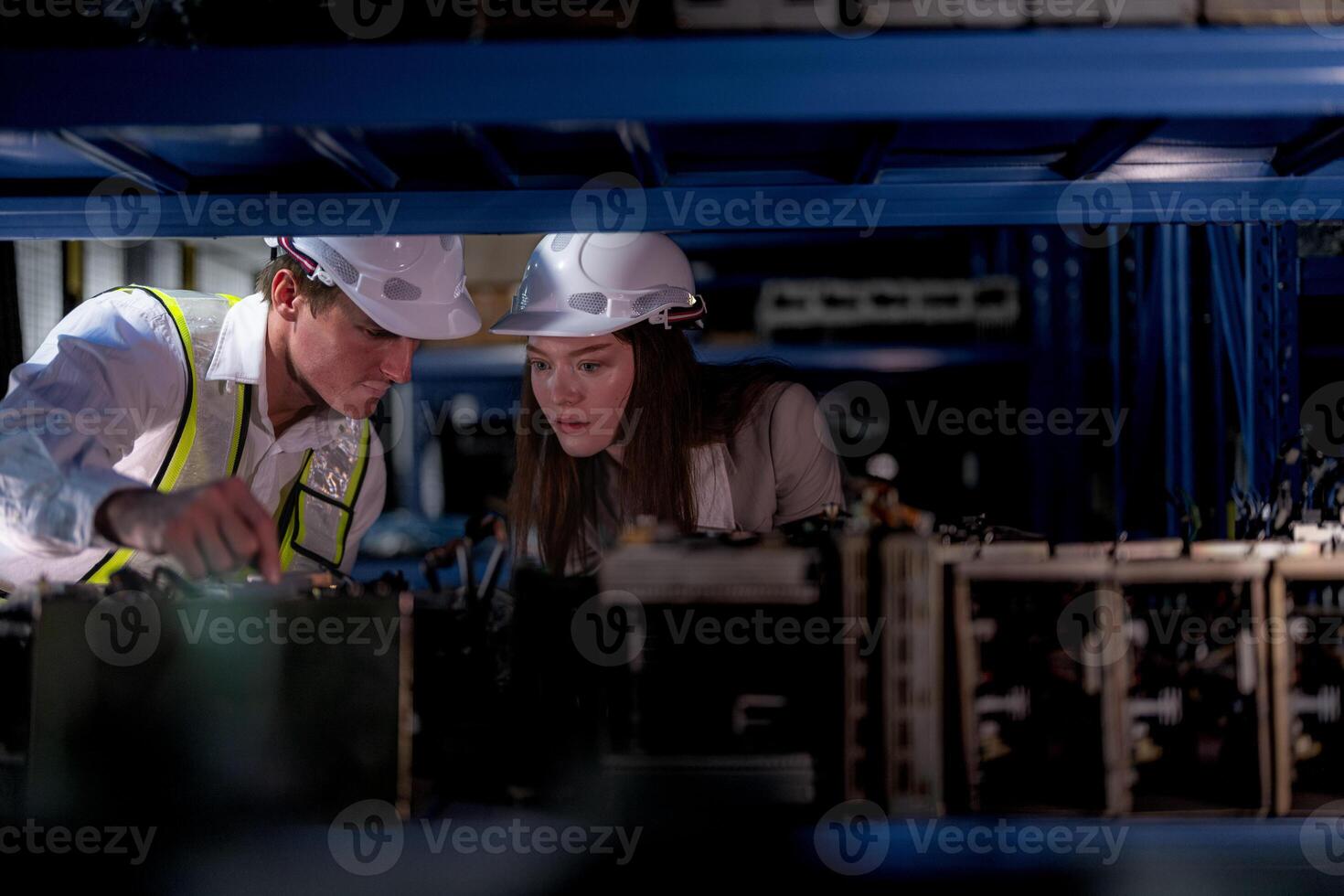 checking and inspecting metal machine part items for shipping. male and woman worker checking the store factory. industry factory warehouse. The warehouse of spare part for machinery and vehicles. photo