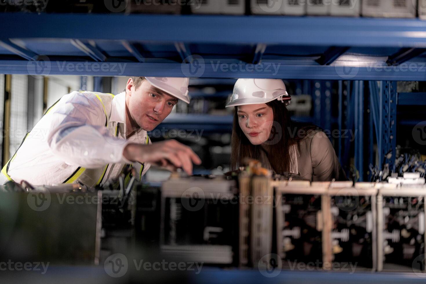 technician engineers team checking the machine and maintenance service. workers looking at spare parts in stock at warehouse factory. laborer with a checklist looking on part of machine parts. photo