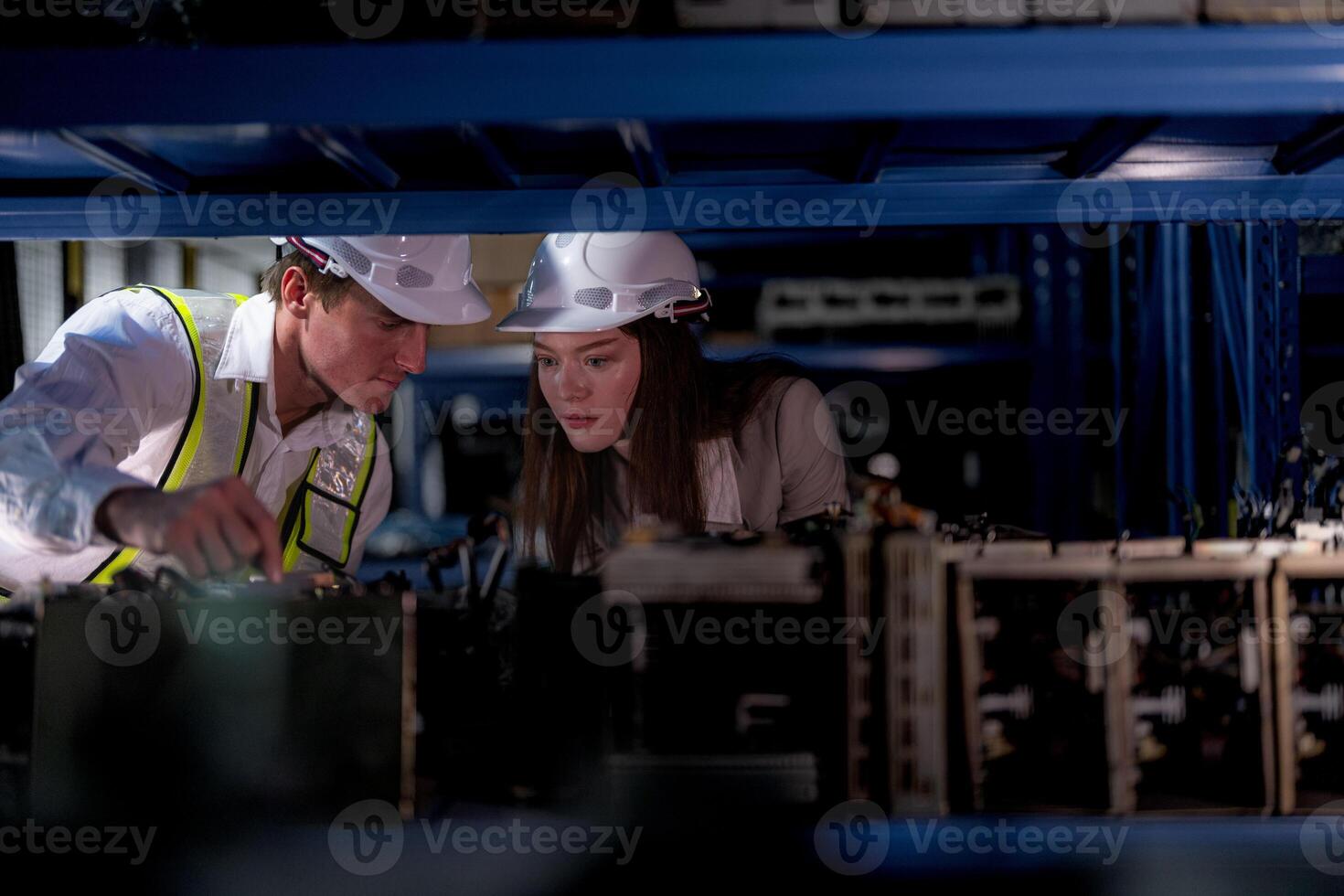 checking and inspecting metal machine part items for shipping. male and woman worker checking the store factory. industry factory warehouse. The warehouse of spare part for machinery and vehicles. photo