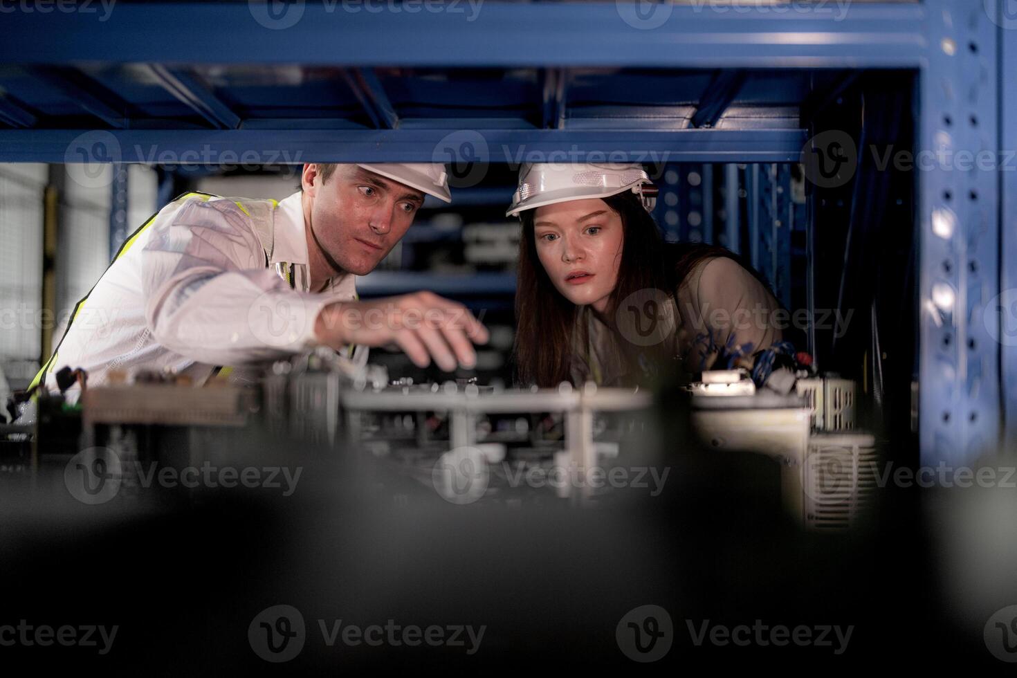 technician engineers team checking the machine and maintenance service. workers looking at spare parts in stock at warehouse factory. laborer with a checklist looking on part of machine parts. photo