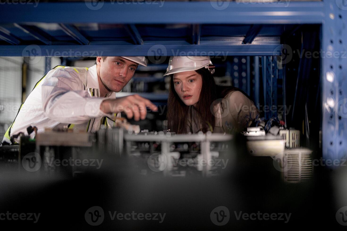 checking and inspecting metal machine part items for shipping. male and woman worker checking the store factory. industry factory warehouse. The warehouse of spare part for machinery and vehicles. photo