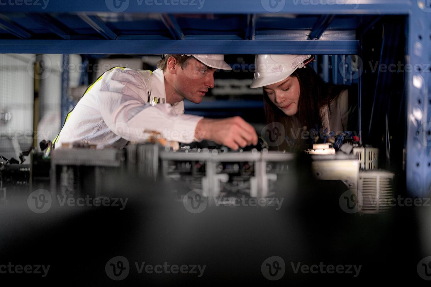 checking and inspecting metal machine part items for shipping. male and woman worker checking the store factory. industry factory warehouse. The warehouse of spare part for machinery and vehicles. photo