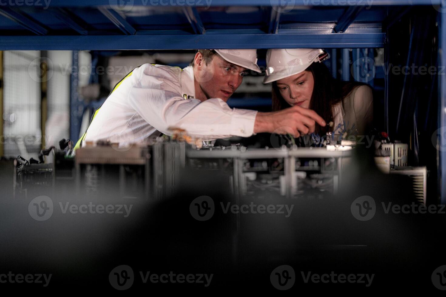 checking and inspecting metal machine part items for shipping. male and woman worker checking the store factory. industry factory warehouse. The warehouse of spare part for machinery and vehicles. photo