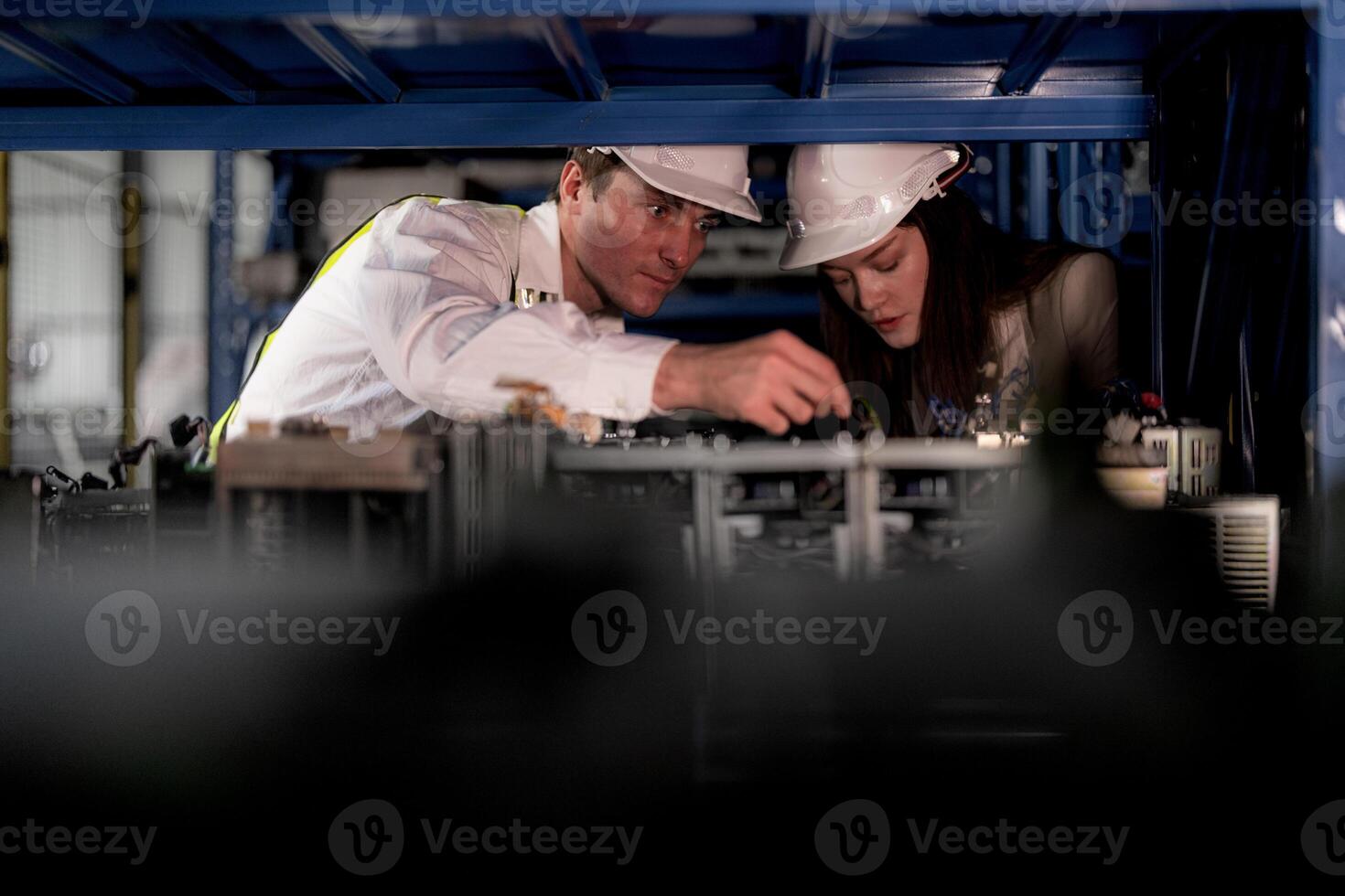 checking and inspecting metal machine part items for shipping. male and woman worker checking the store factory. industry factory warehouse. The warehouse of spare part for machinery and vehicles. photo