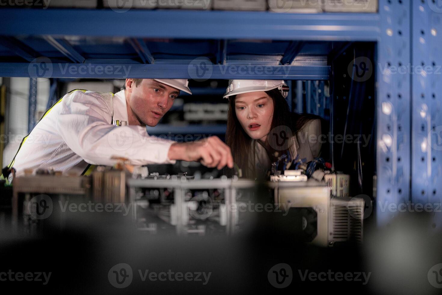 technician engineers team checking the machine and maintenance service. workers looking at spare parts in stock at warehouse factory. laborer with a checklist looking on part of machine parts. photo