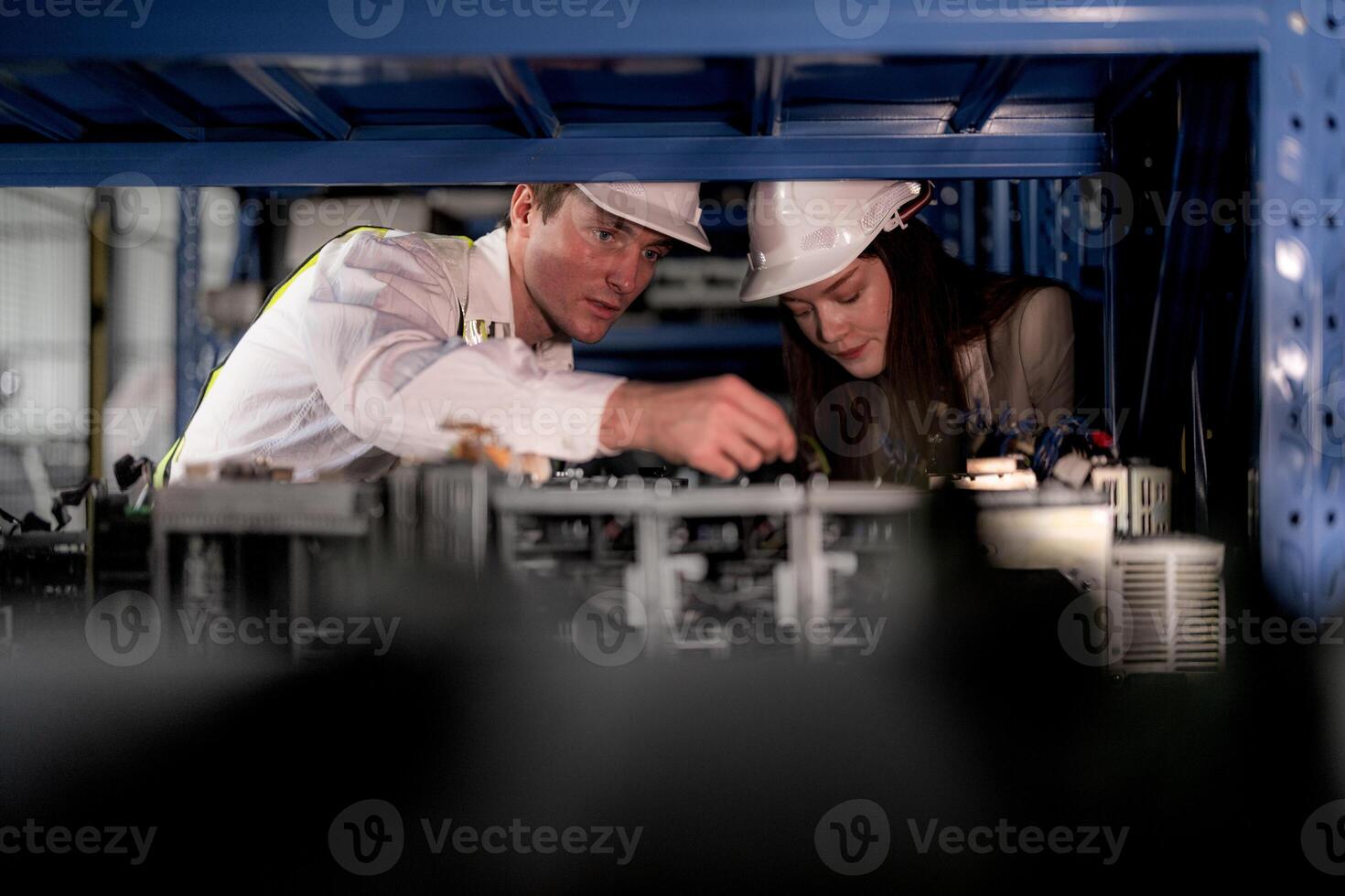 checking and inspecting metal machine part items for shipping. male and woman worker checking the store factory. industry factory warehouse. The warehouse of spare part for machinery and vehicles. photo