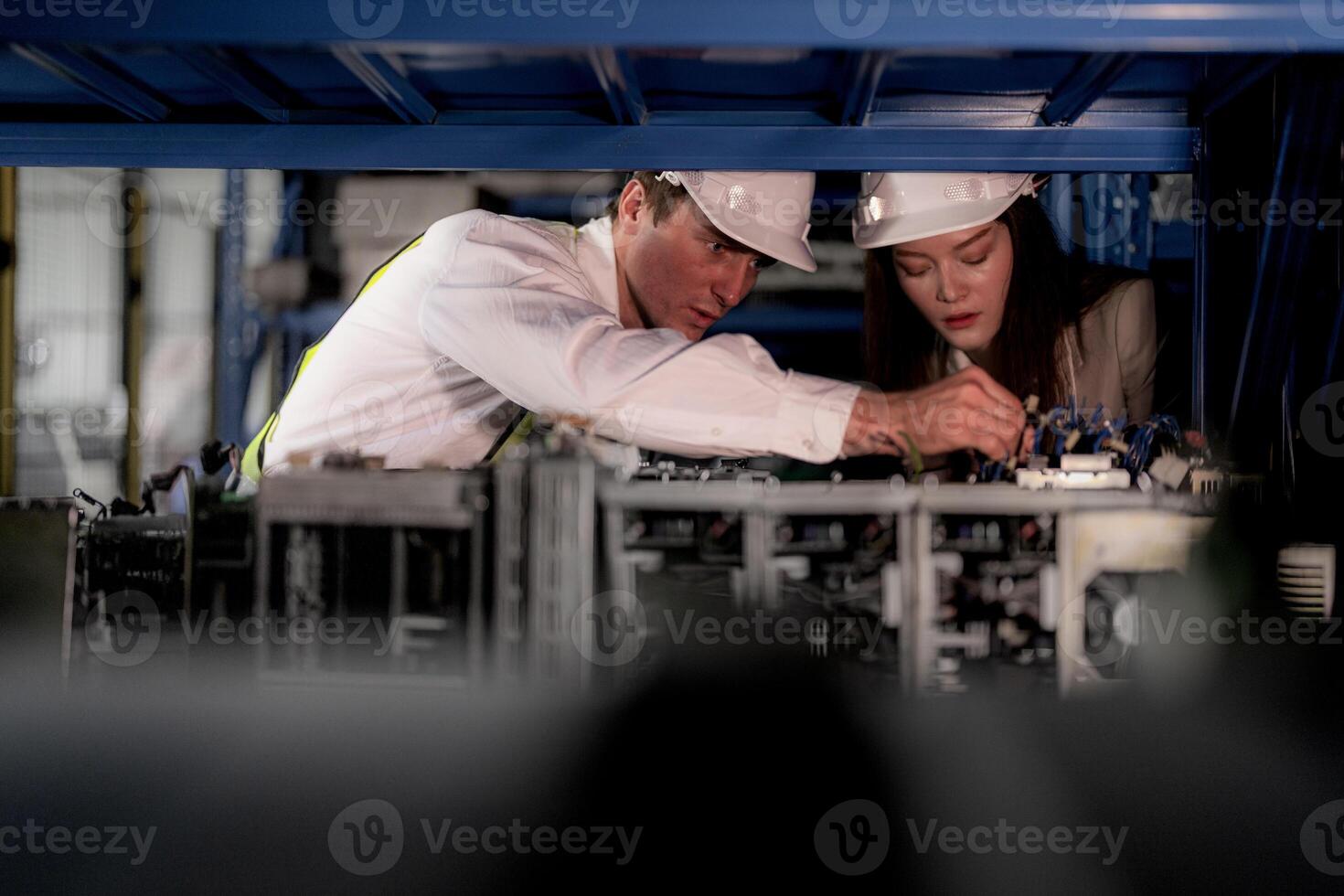 technician engineers team checking the machine and maintenance service. workers looking at spare parts in stock at warehouse factory. laborer with a checklist looking on part of machine parts. photo