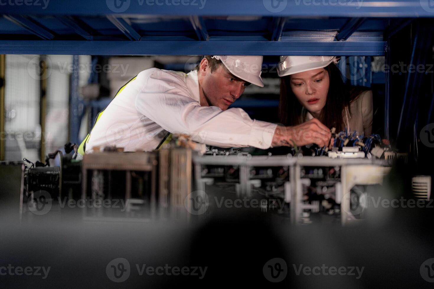 technician engineers team checking the machine and maintenance service. workers looking at spare parts in stock at warehouse factory. laborer with a checklist looking on part of machine parts. photo