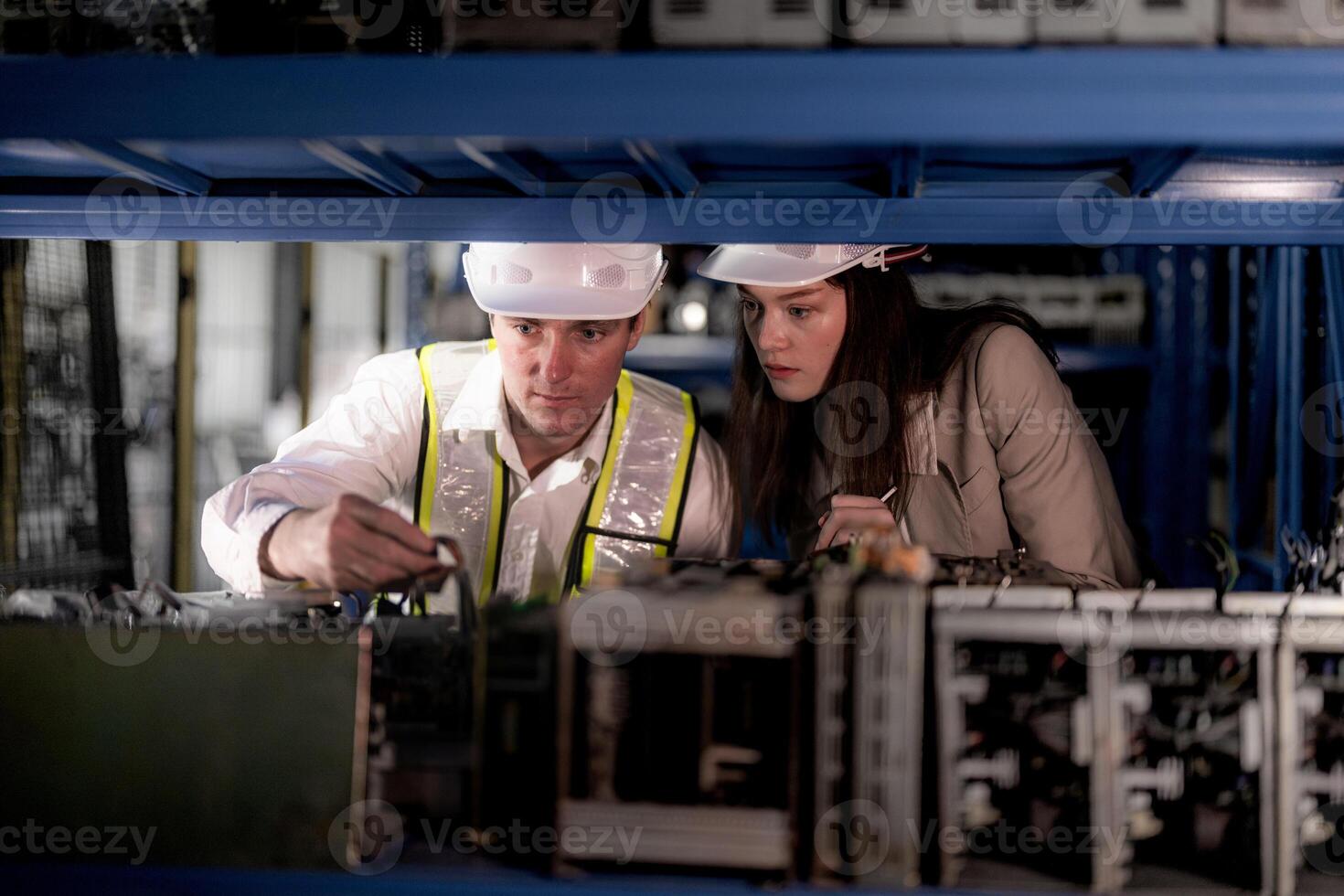 checking and inspecting metal machine part items for shipping. male and woman worker checking the store factory. industry factory warehouse. The warehouse of spare part for machinery and vehicles. photo