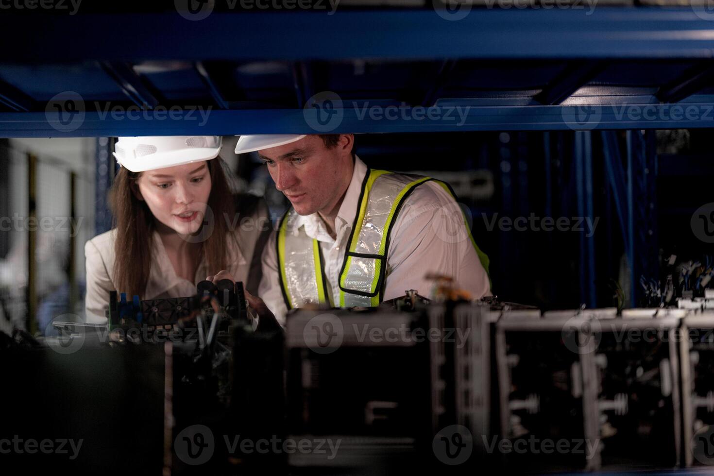 checking and inspecting metal machine part items for shipping. male and woman worker checking the store factory. industry factory warehouse. The warehouse of spare part for machinery and vehicles. photo