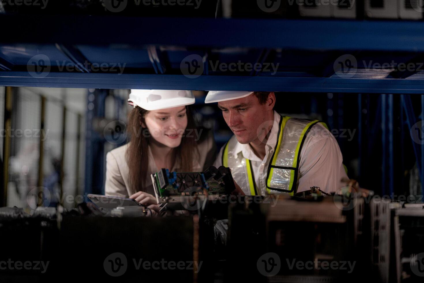 checking and inspecting metal machine part items for shipping. male and woman worker checking the store factory. industry factory warehouse. The warehouse of spare part for machinery and vehicles. photo
