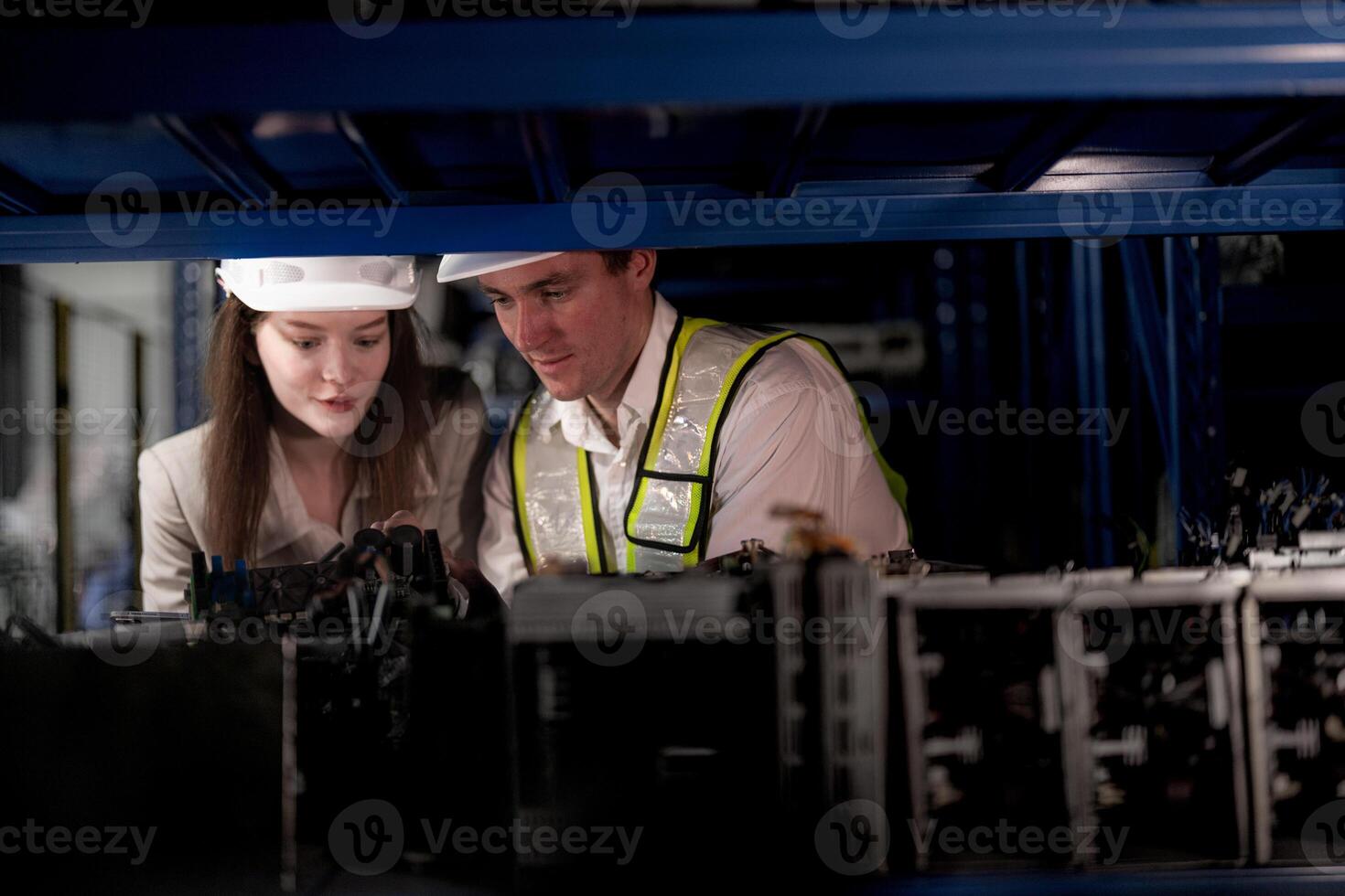 checking and inspecting metal machine part items for shipping. male and woman worker checking the store factory. industry factory warehouse. The warehouse of spare part for machinery and vehicles. photo