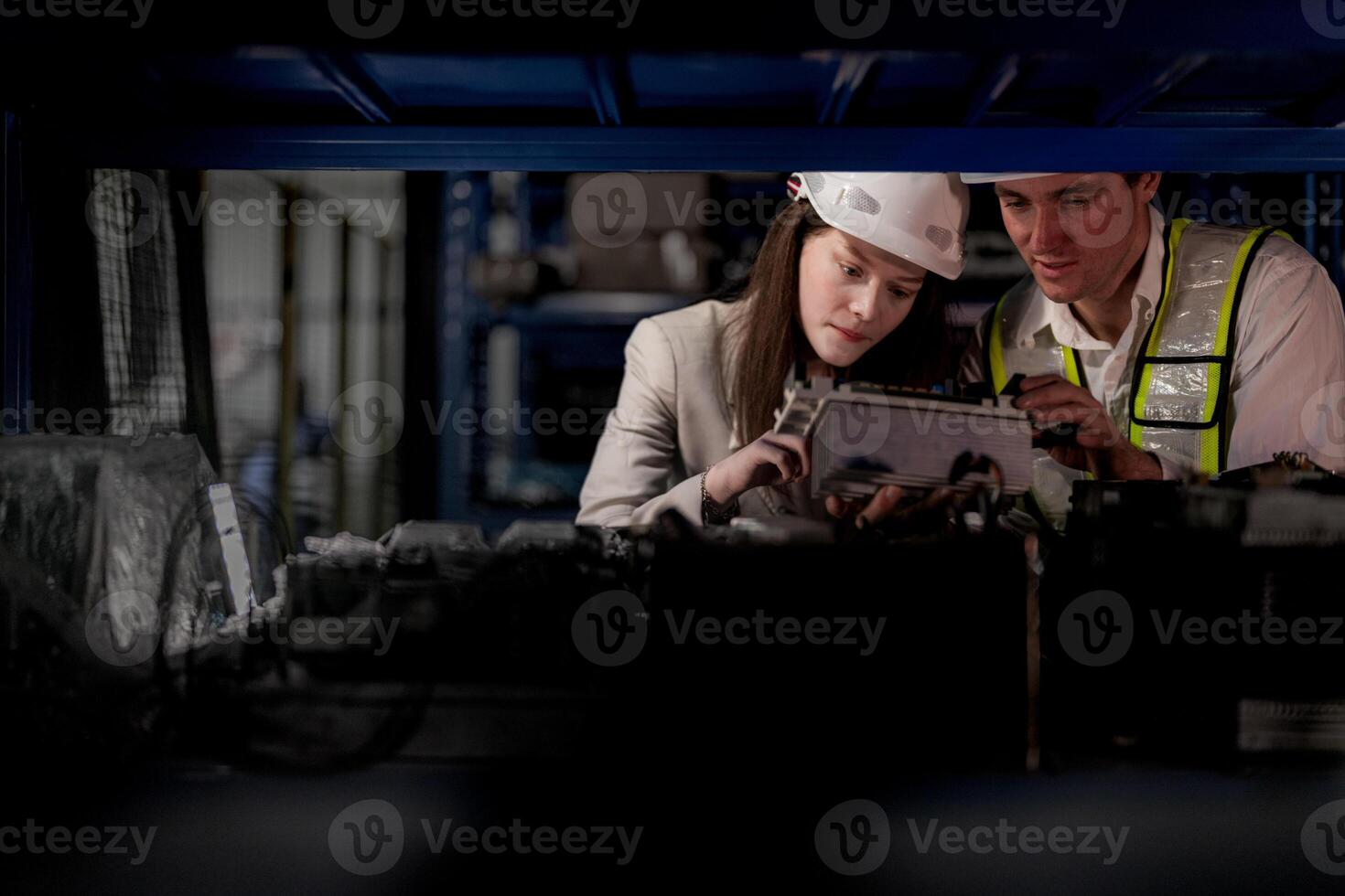 checking and inspecting metal machine part items for shipping. male and woman worker checking the store factory. industry factory warehouse. The warehouse of spare part for machinery and vehicles. photo