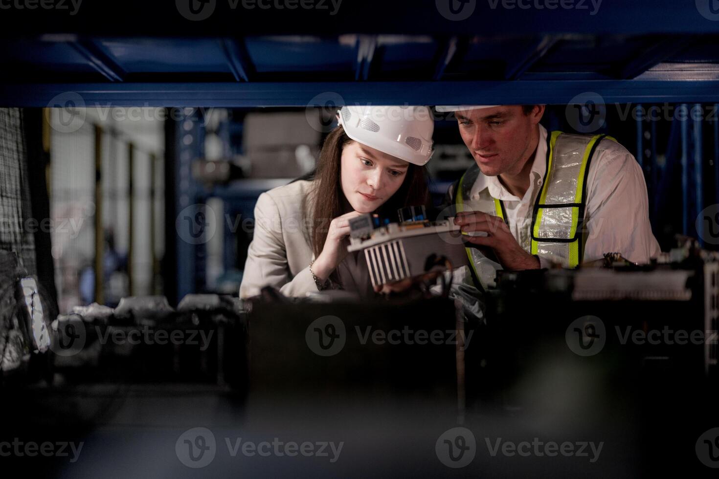 checking and inspecting metal machine part items for shipping. male and woman worker checking the store factory. industry factory warehouse. The warehouse of spare part for machinery and vehicles. photo