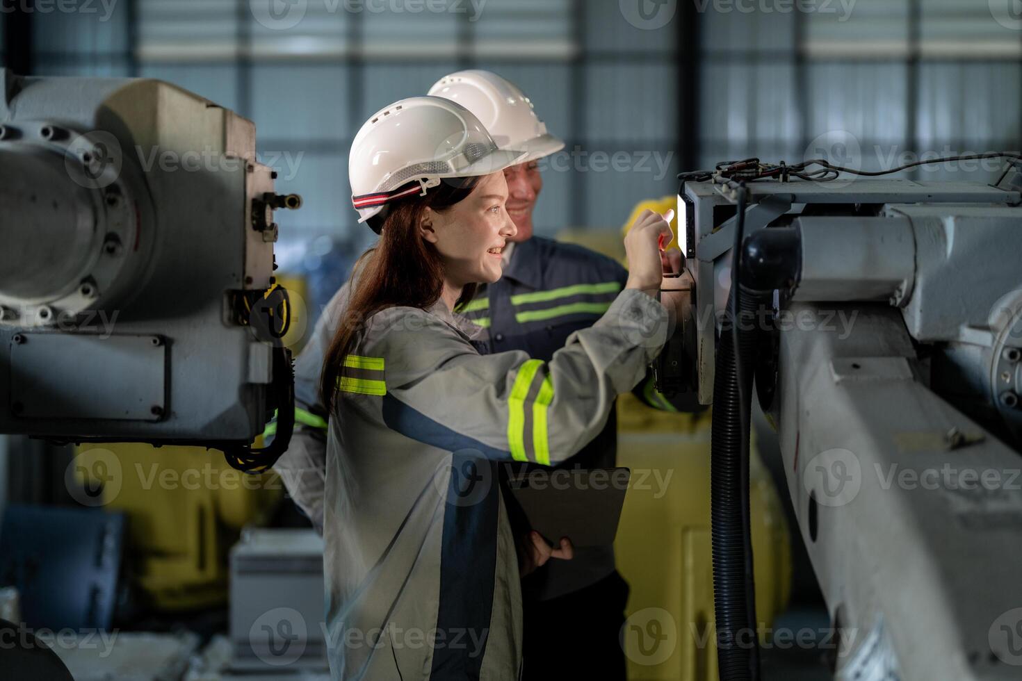 engineers check control heavy machine robot arm. Diverse Team of Industrial Robotics Engineers Gathered Around Machine. Professional Machinery Operators repair electric robot on bright digital panel. photo