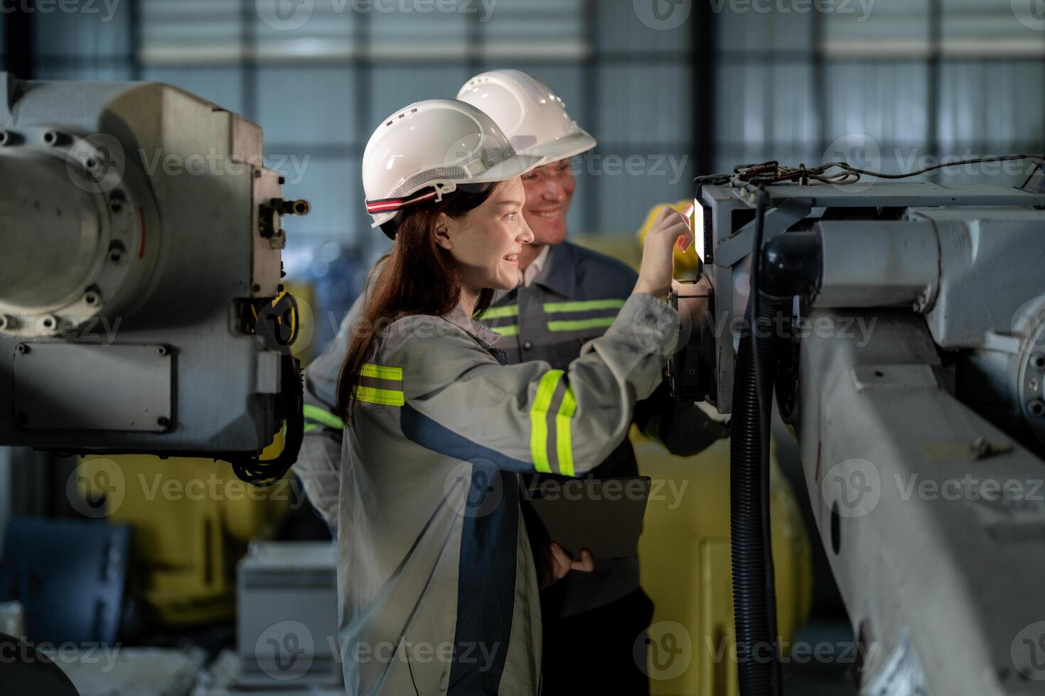 engineers check control heavy machine robot arm. Diverse Team of Industrial Robotics Engineers Gathered Around Machine. Professional Machinery Operators repair electric robot on bright digital panel. photo