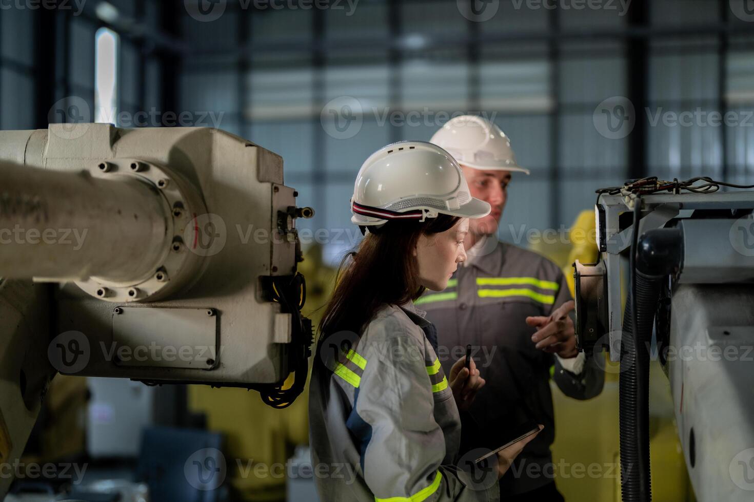 engineers check control heavy machine robot arm. Diverse Team of Industrial Robotics Engineers Gathered Around Machine. Professional Machinery Operators repair electric robot on bright digital panel. photo