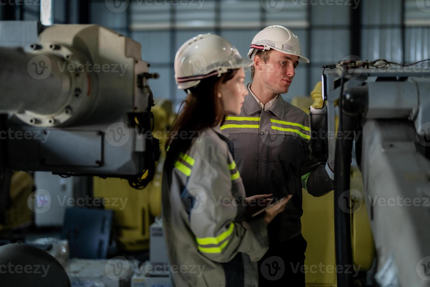 engineers check control heavy machine robot arm. Diverse Team of Industrial Robotics Engineers Gathered Around Machine. Professional Machinery Operators repair electric robot on bright digital panel. photo