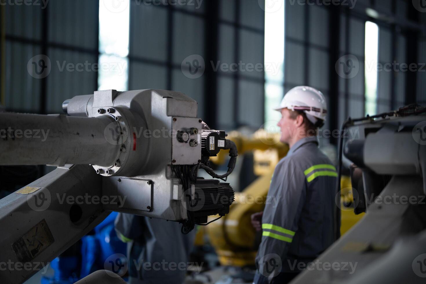 engineers check control heavy machine robot arm. Diverse Team of Industrial Robotics Engineers Gathered Around Machine. Professional Machinery Operators repair electric robot on bright digital panel. photo
