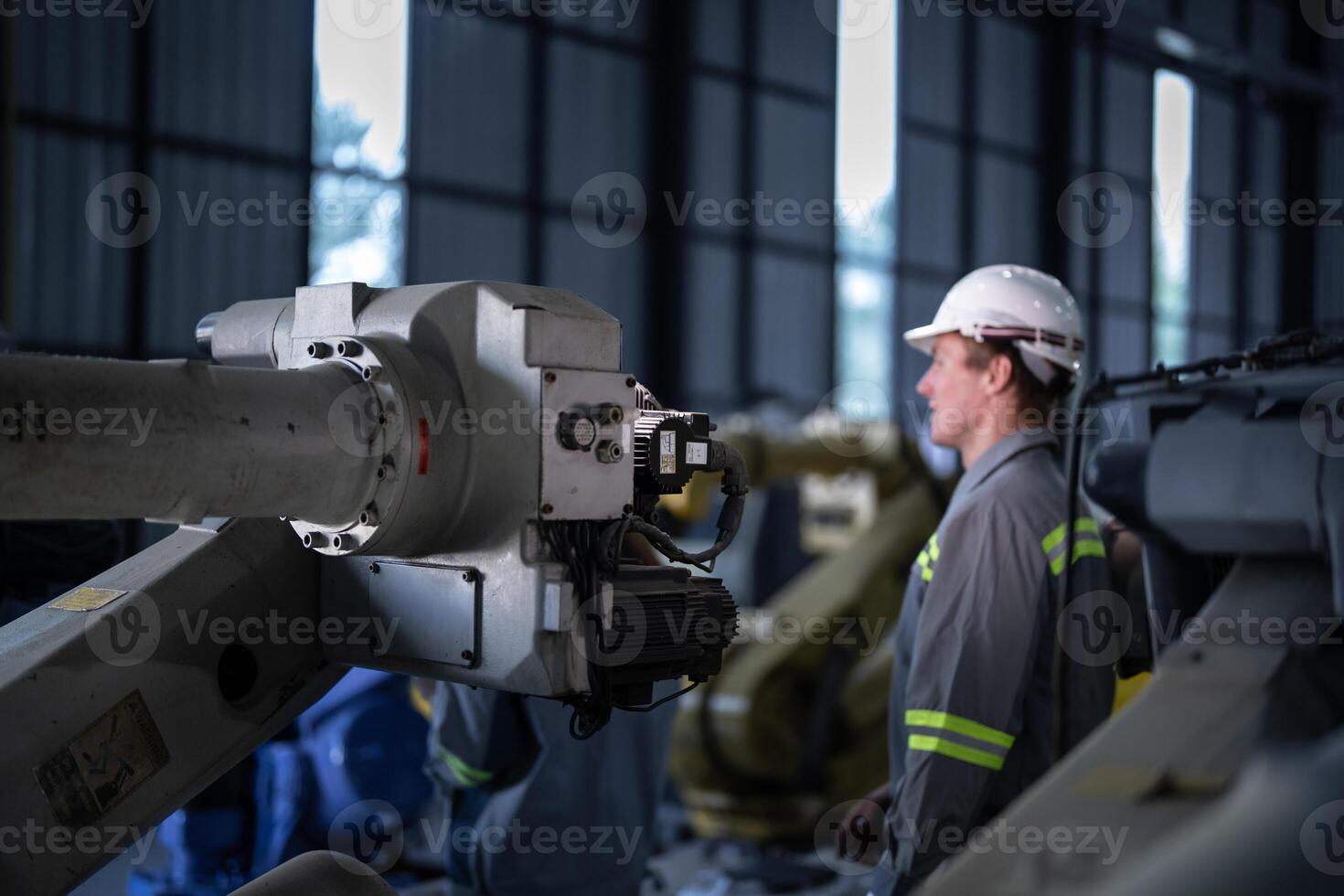 engineers check control heavy machine robot arm. Diverse Team of Industrial Robotics Engineers Gathered Around Machine. Professional Machinery Operators repair electric robot on bright digital panel. photo