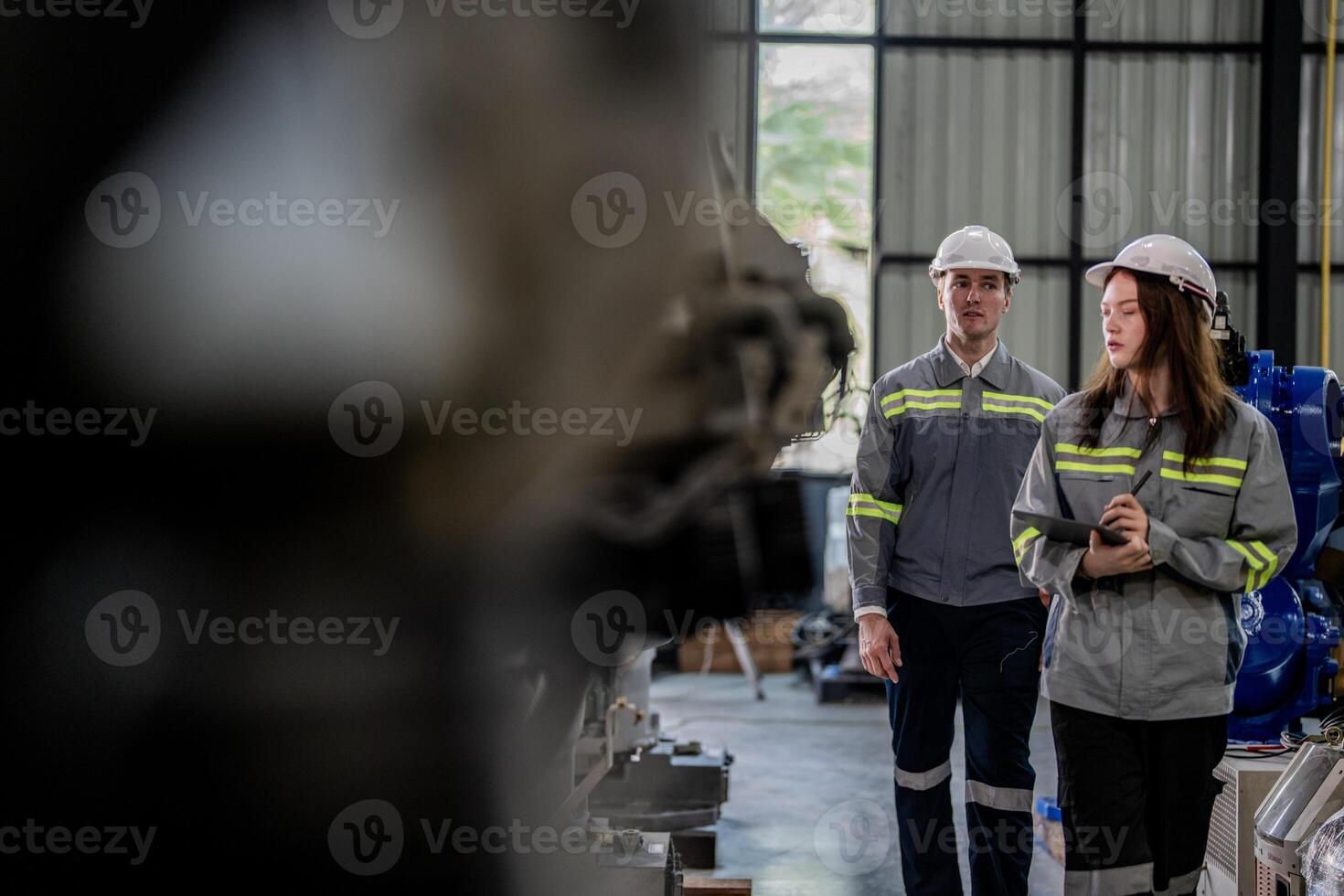 engineers check control heavy machine robot arm. Diverse Team of Industrial Robotics Engineers Gathered Around Machine. Professional Machinery Operators repair electric robot on bright digital panel. photo
