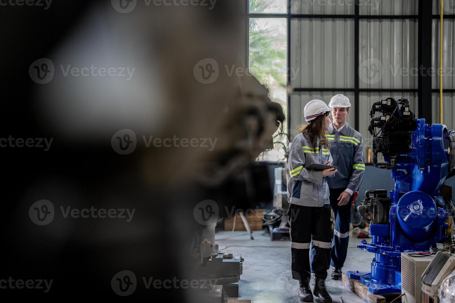 engineers check control heavy machine robot arm. Diverse Team of Industrial Robotics Engineers Gathered Around Machine. Professional Machinery Operators repair electric robot on bright digital panel. photo