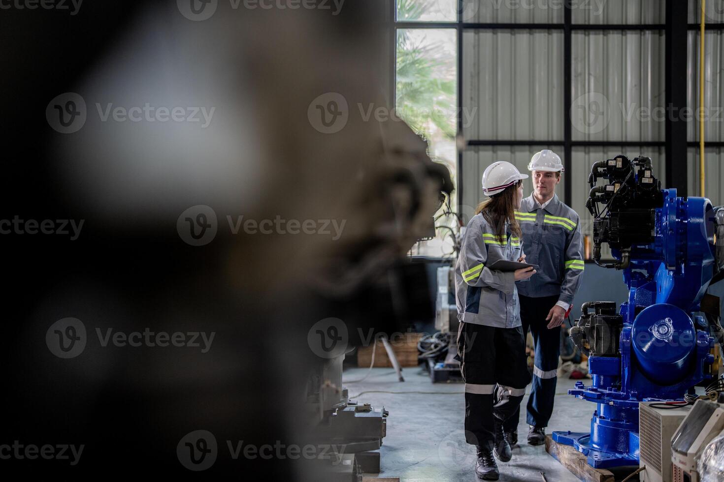 engineers check control heavy machine robot arm. Diverse Team of Industrial Robotics Engineers Gathered Around Machine. Professional Machinery Operators repair electric robot on bright digital panel. photo