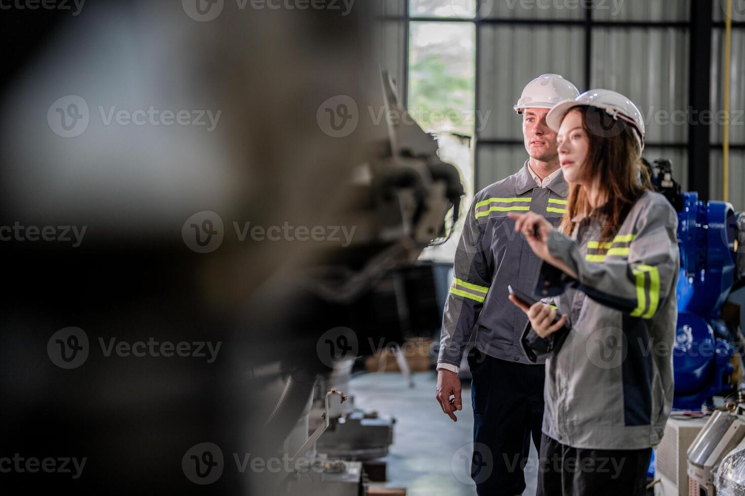 engineers check control heavy machine robot arm. Diverse Team of Industrial Robotics Engineers Gathered Around Machine. Professional Machinery Operators repair electric robot on bright digital panel. photo