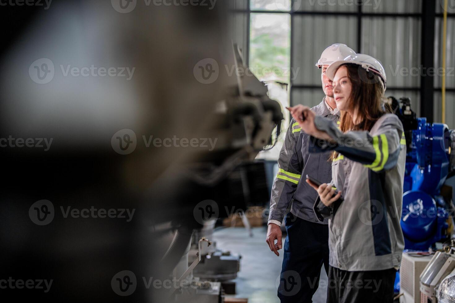 engineers check control heavy machine robot arm. Diverse Team of Industrial Robotics Engineers Gathered Around Machine. Professional Machinery Operators repair electric robot on bright digital panel. photo