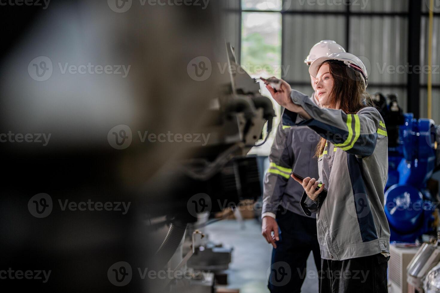engineers check control heavy machine robot arm. Diverse Team of Industrial Robotics Engineers Gathered Around Machine. Professional Machinery Operators repair electric robot on bright digital panel. photo